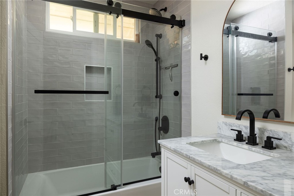 602 Calle Ganadero San Clemente, CA 92673 - Photo 27 of 42 a bathroom with a granite countertop sink a shower and a mirror