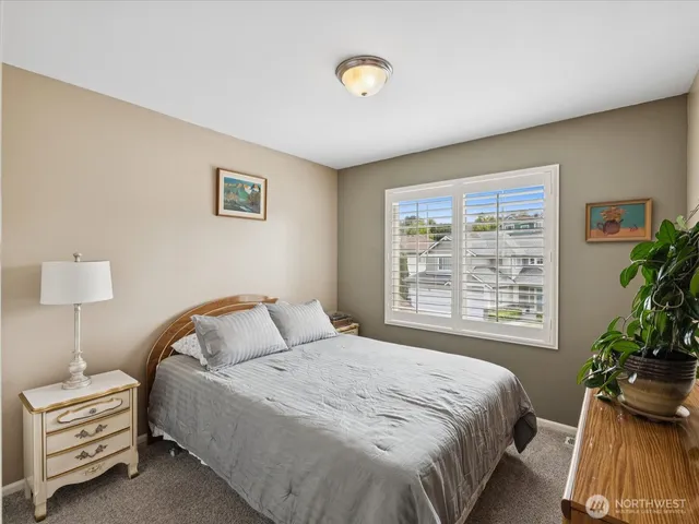 a bedroom with a bed and a potted plant