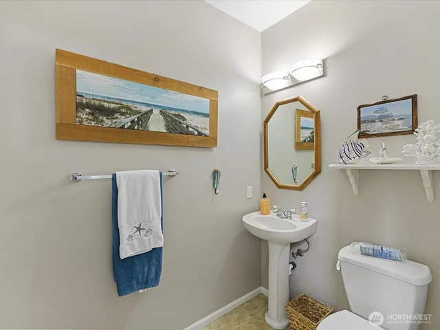 a bathroom with a toilet a sink and a mirror