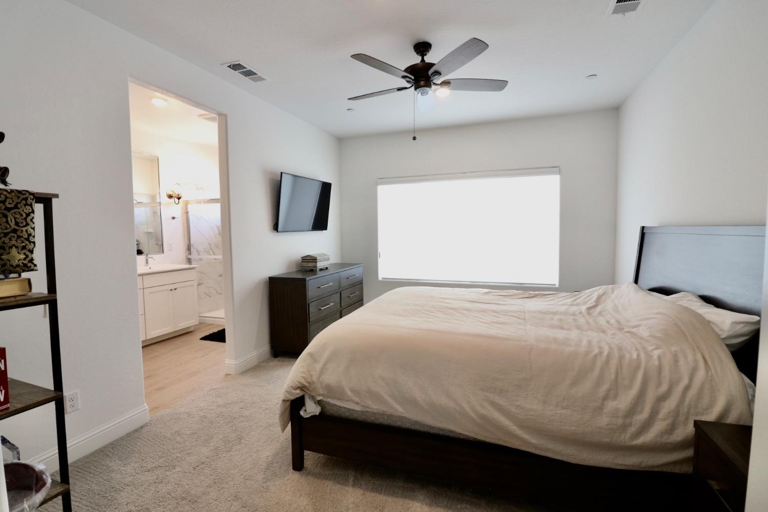 240 Huntington Avenue Madera, CA 93636 - Photo 13 of 24 a bedroom with a bed and a flat screen tv