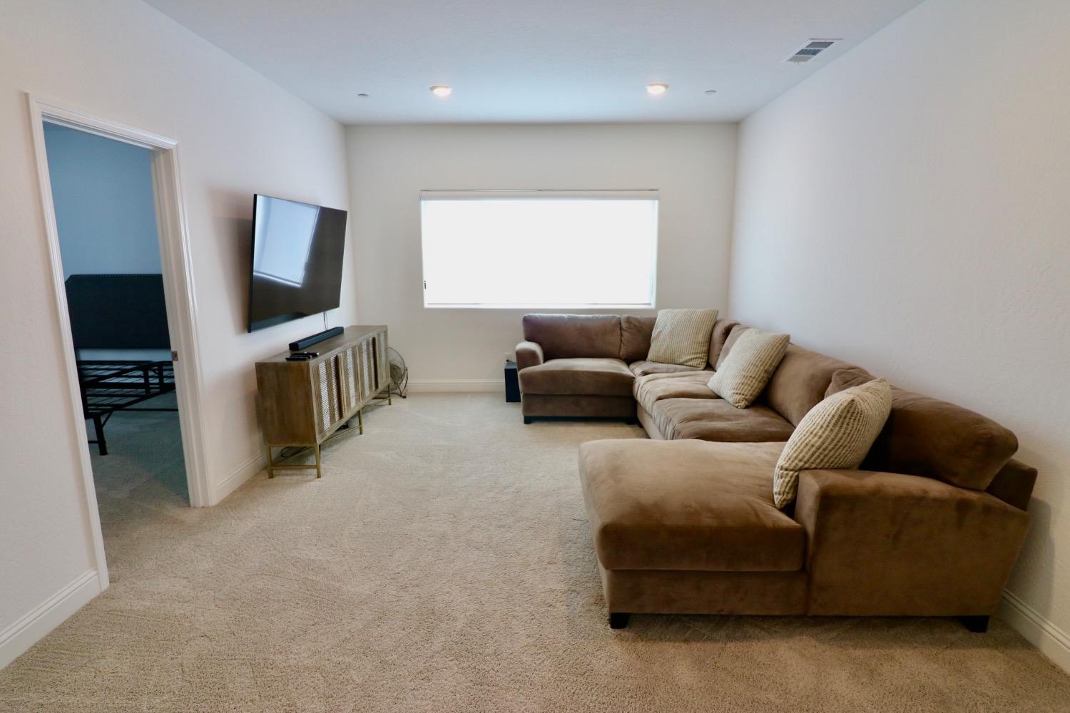 240 Huntington Avenue Madera, CA 93636 - Photo 17 of 24 a living room with furniture and a flat screen tv
