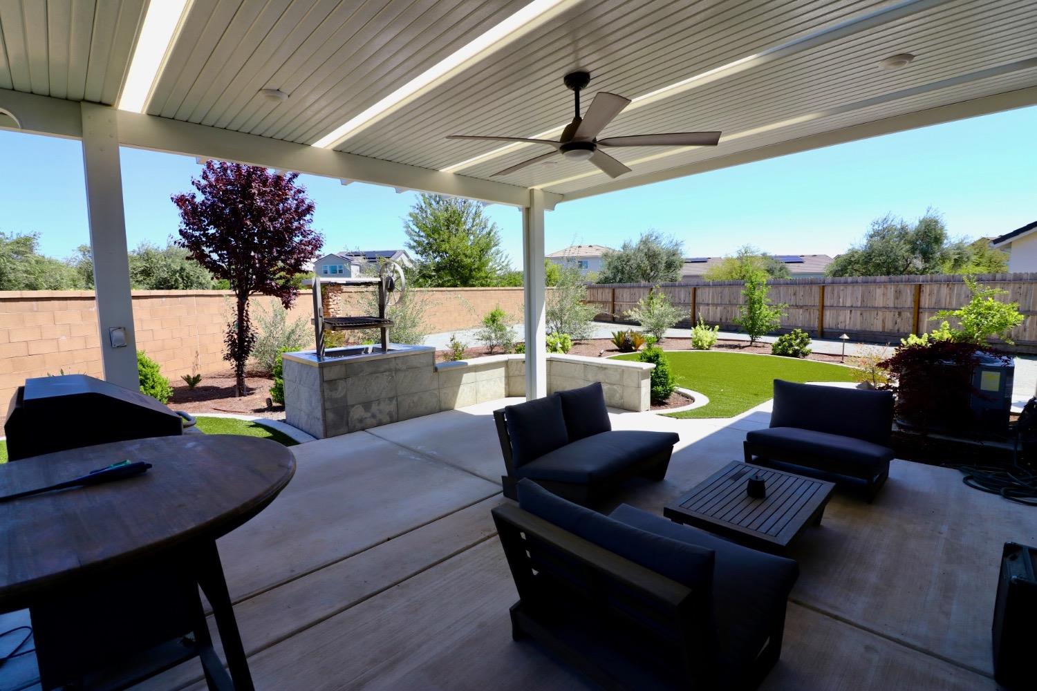 240 Huntington Avenue Madera, CA 93636 - Photo 19 of 24 a living room with patio furniture and a garden