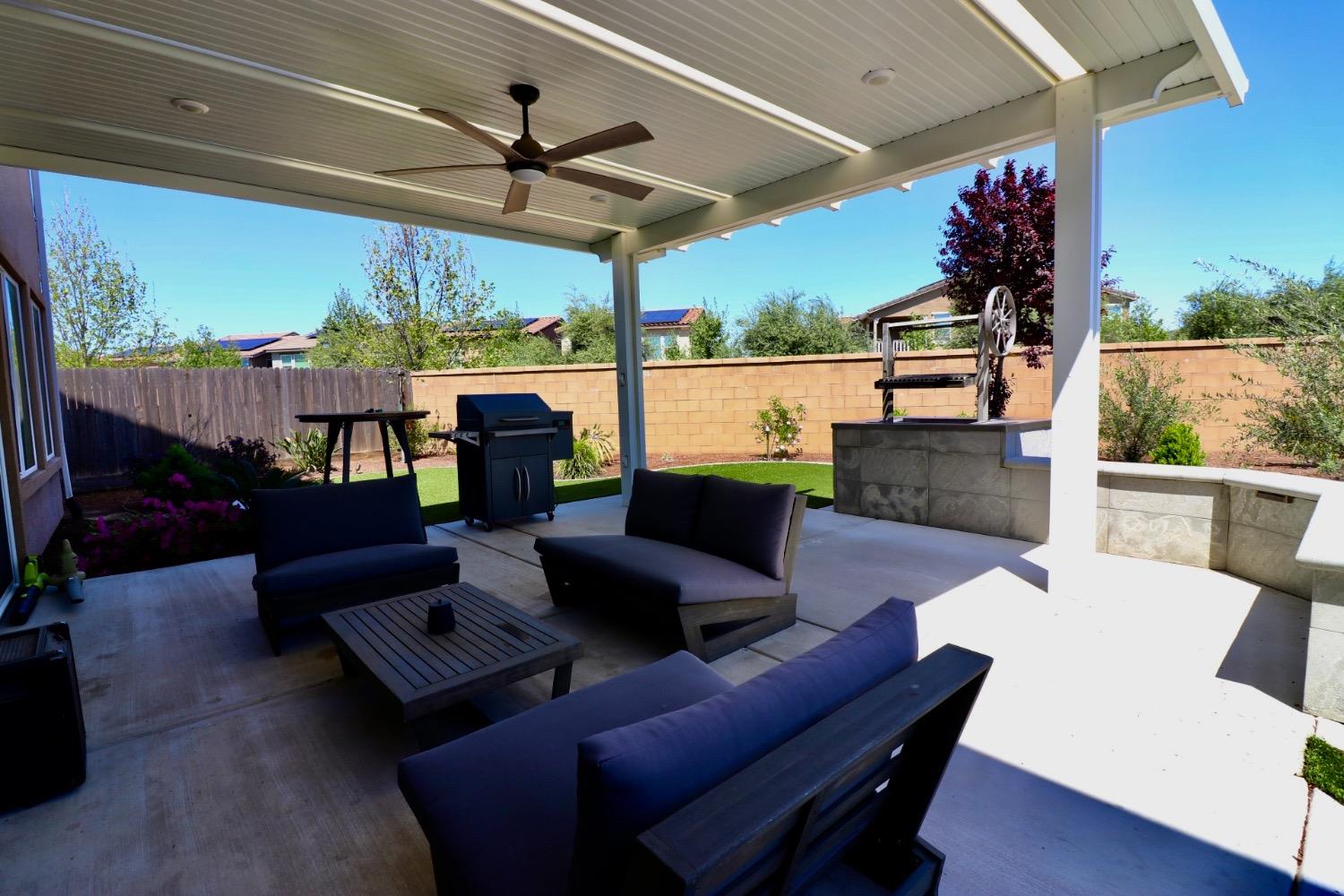 240 Huntington Avenue Madera, CA 93636 - Photo 20 of 24 a living room with patio furniture and a floor to ceiling window
