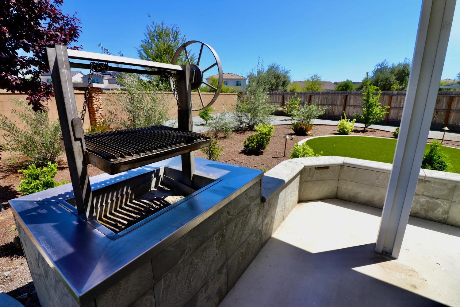 240 Huntington Avenue Madera, CA 93636 - Photo 22 of 24 a view of a patio with a table chairs and a potted plant