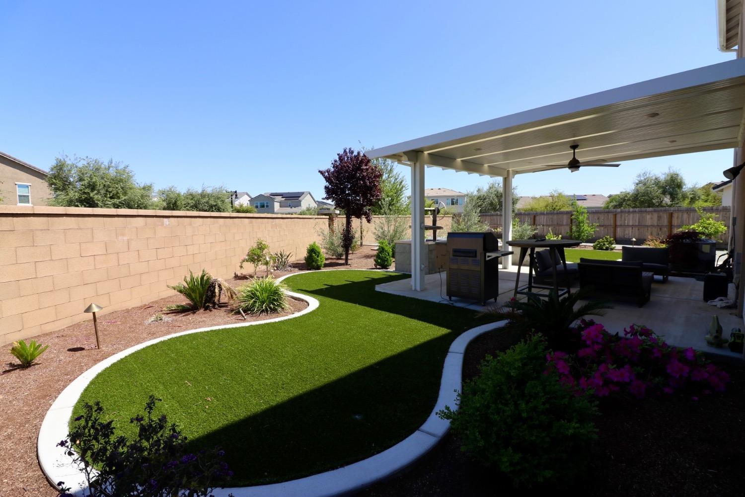 240 Huntington Avenue Madera, CA 93636 - Photo 24 of 24 a view of a swimming pool with lawn chairs and a potted plants