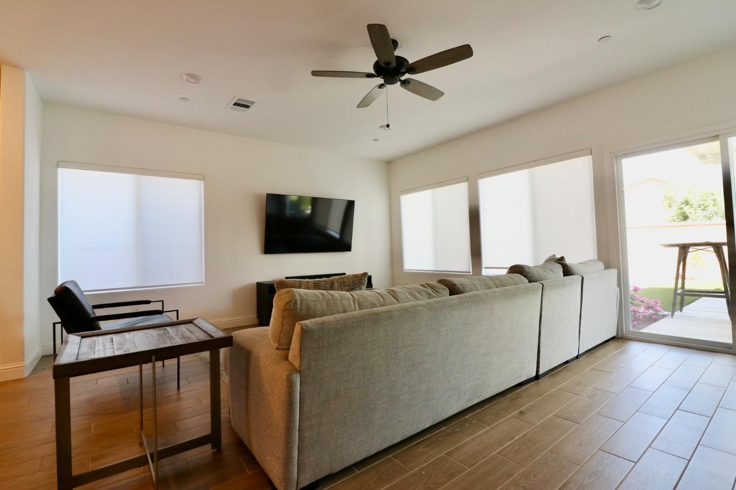 240 Huntington Avenue Madera, CA 93636 - Photo 4 of 24 a living room with furniture and a flat screen tv