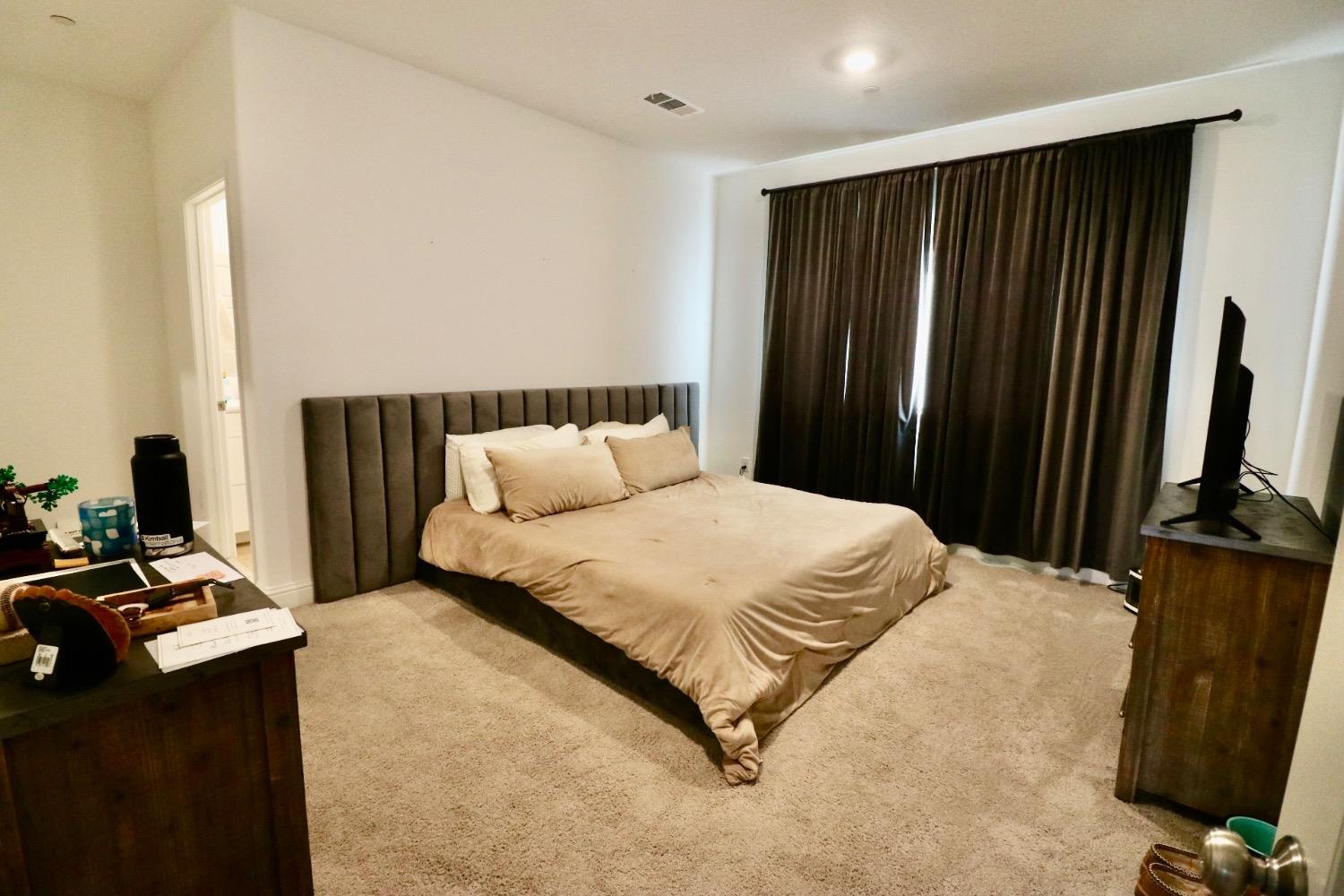 240 Huntington Avenue Madera, CA 93636 - Photo 5 of 24 a bedroom with a bed and a flat screen tv