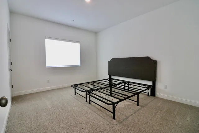 a living room with furniture and a air conditioner vent