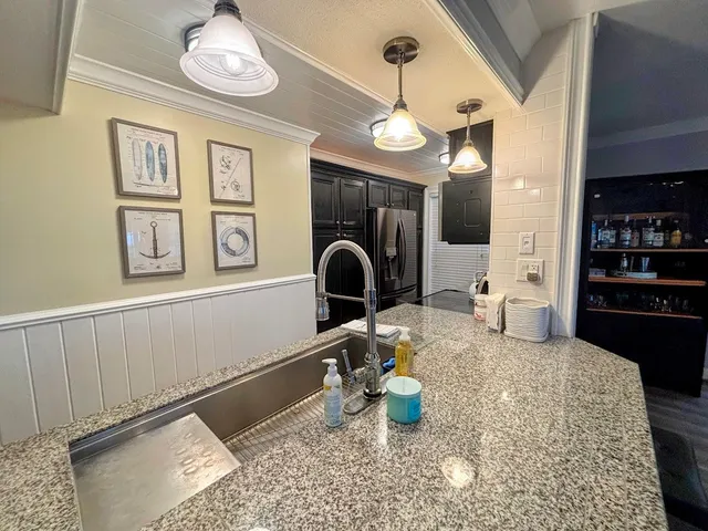 a kitchen with a sink and a stove top oven