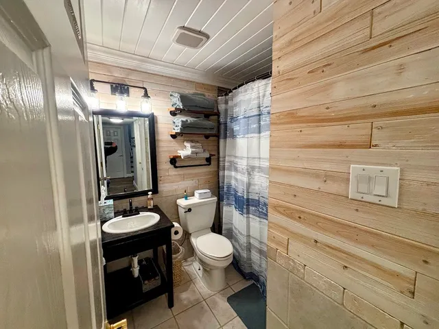 a bathroom with a double vanity sink toilet and shower