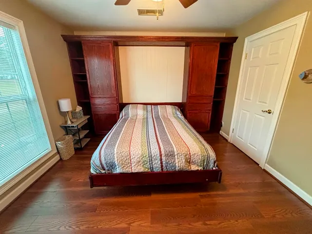 a bed sitting in a bedroom next to a window