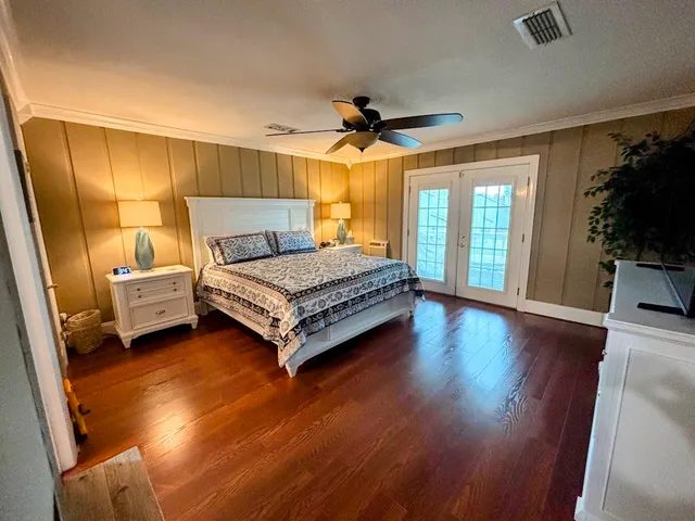 a bedroom with a bed couch and a window
