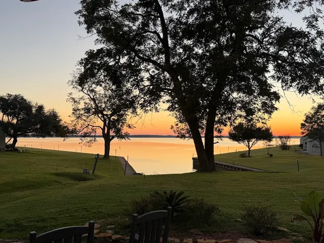 a view of outdoor space with green field and trees