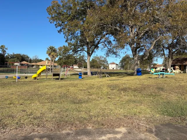 a view of outdoor space with playground and green space