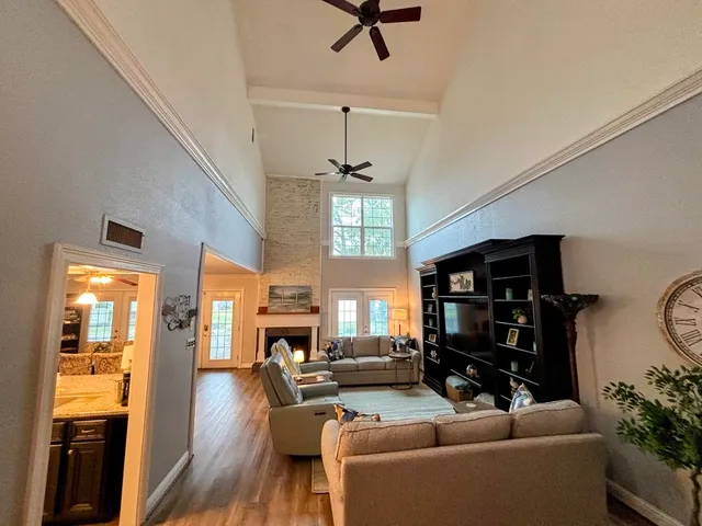 a living room with furniture a window and a chandelier