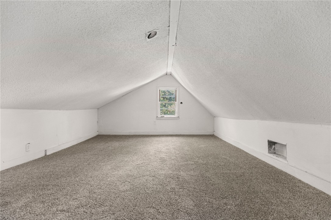 109 Farmer Street Anderson, SC 29621 - Photo 30 of 31 A quaint window offers natural light in this carpeted attic space, perfect for storage or future expansion.