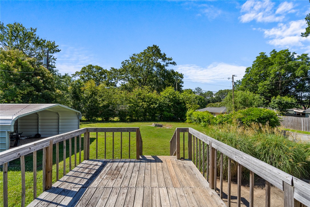 419 Whitehall Road Anderson, SC 29625 - Photo 20 of 28 A spacious wooden deck provides ample room for outdoor relaxation, overlooking a verdant lawn.
