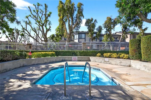a view of a patio with table and chairs potted plants with floor to ceiling window and plants