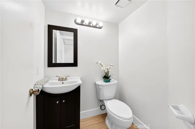 a bathroom with a toilet a sink and mirror