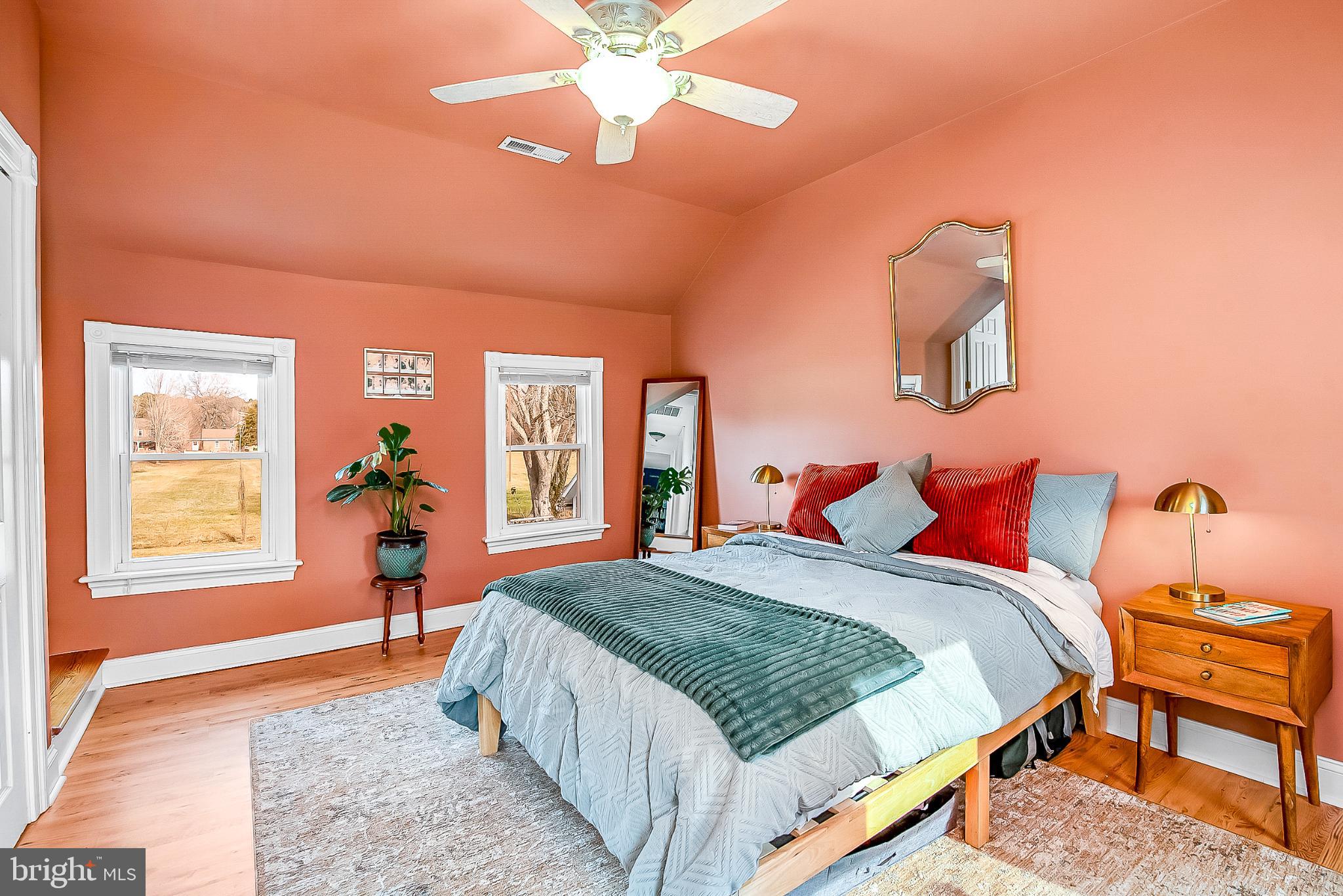 22582 Pot Pie Road Wittman, MD 21676 - Photo 20 of 36 a bedroom with a bed and a chandelier