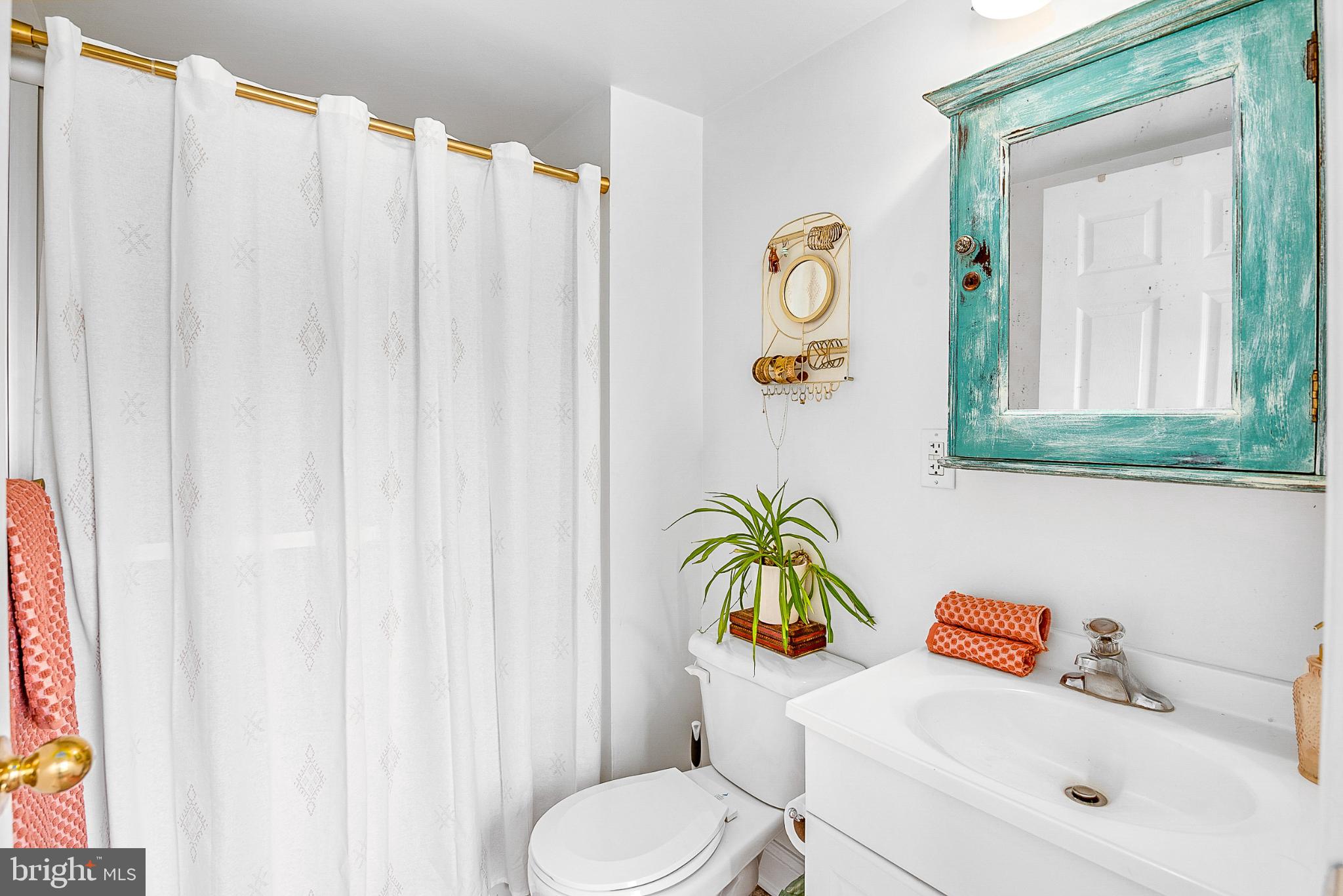 22582 Pot Pie Road Wittman, MD 21676 - Photo 23 of 36 a bathroom with a sink a toilet and a window