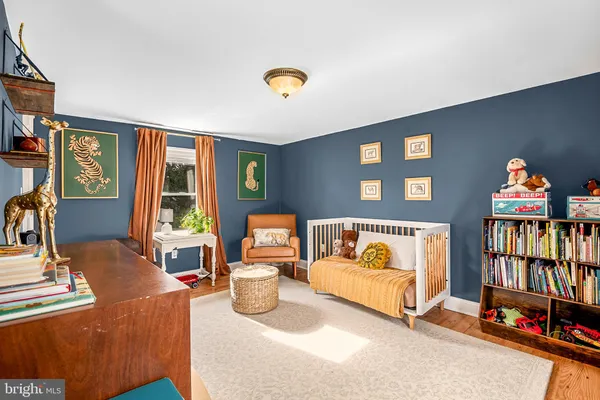 a bedroom with furniture and a book shelf