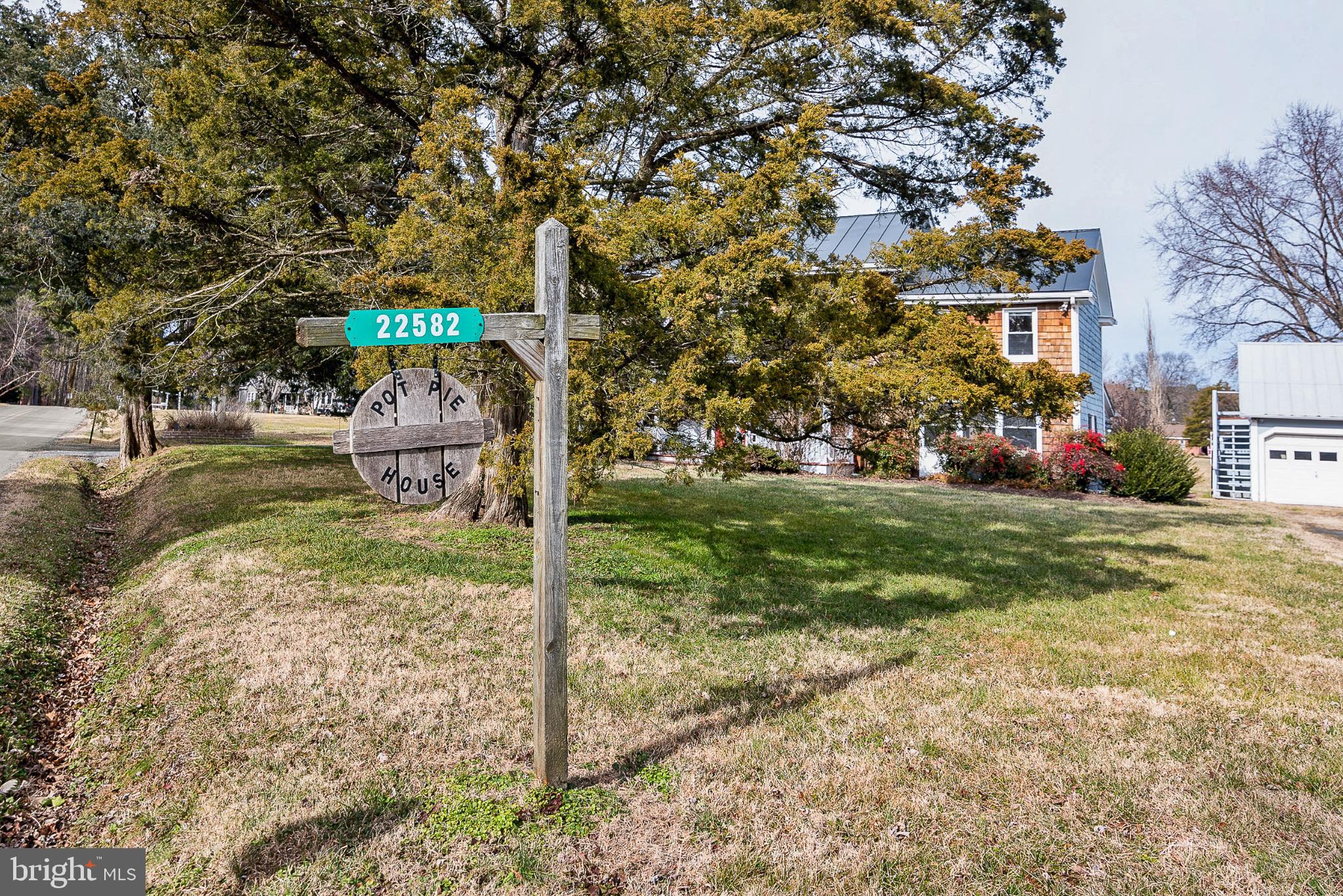 22582 Pot Pie Road Wittman, MD 21676 - Photo 3 of 36 a front view of a house with garden
