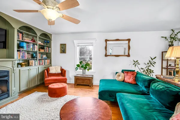 a living room with furniture a rug and a book shelf