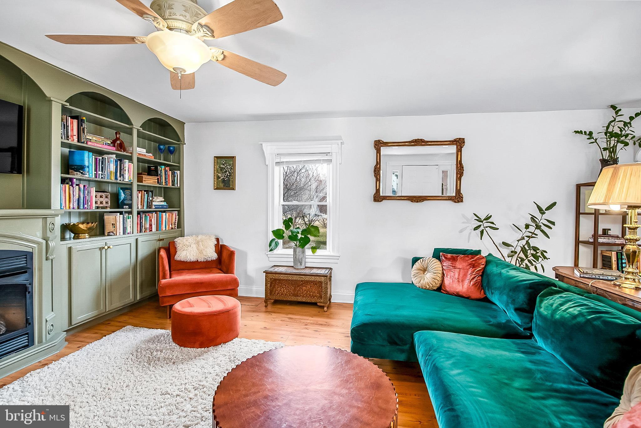 22582 Pot Pie Road Wittman, MD 21676 - Photo 7 of 36 a living room with furniture a rug and a book shelf
