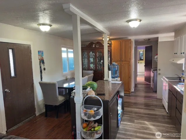 a dining room with furniture and wooden floor