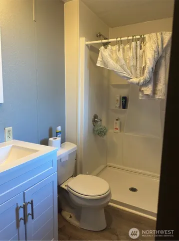 a bathroom with a toilet and a shower