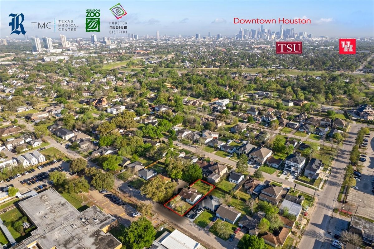 Aerial view of a residential neighborhood with lush greenery, showcasing proximity to downtown Houston and major attractions like the Texas Medical Center, Houston Zoo, and universities. The area is well-developed with a mix of houses and amenities, providing a convenient urban lifestyle.