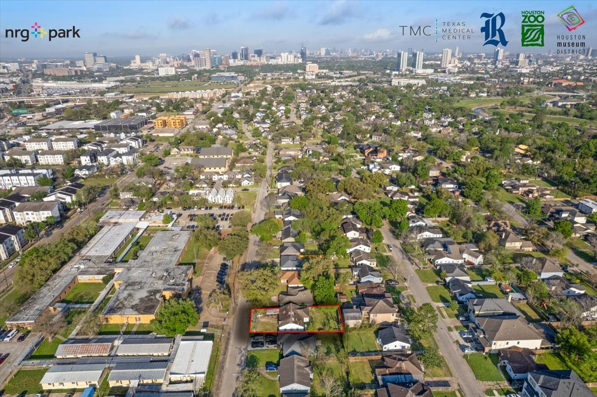3535 Tampa Street Houston, TX 77021 - Photo 2 of 19 This aerial photo showcases a residential area with a mix of homes and greenery. The neighborhood is well-established, offering proximity to local amenities and city views in the distance. The red outline highlights a specific property.