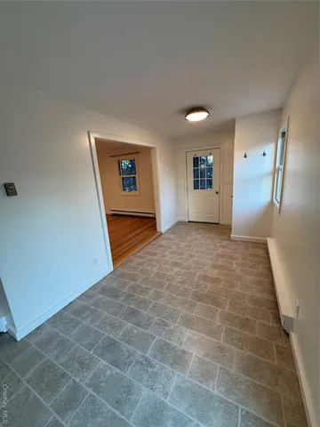 a view of a big room with a staircase and a ceiling fan