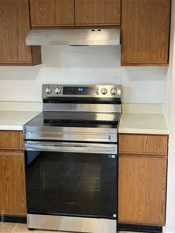 a stove top oven sitting inside of a kitchen
