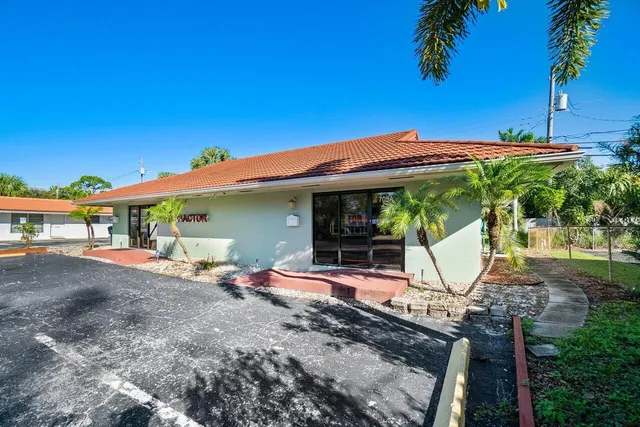 a view of a house with backyard and sitting area