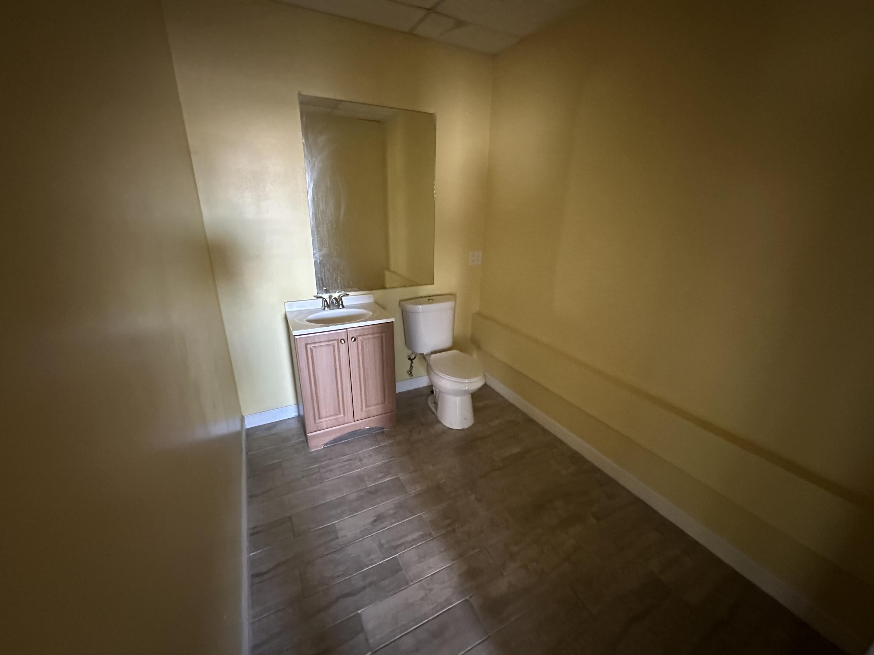705 Park Avenue, Unit A Lake Park, FL 33403 - Photo 16 of 28 a bathroom with a sink and a toilet