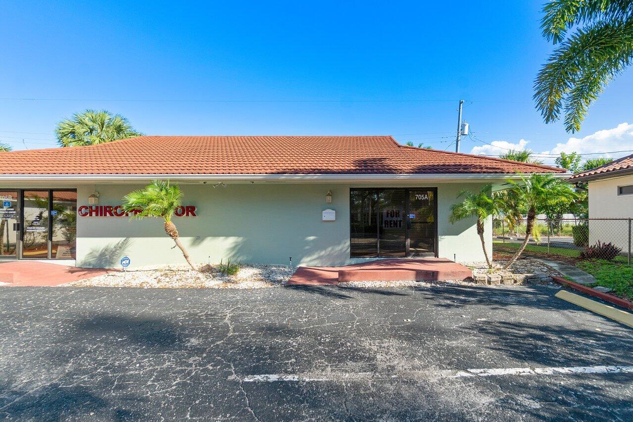 705 Park Avenue, Unit A Lake Park, FL 33403 - Photo 2 of 28 a front view of a house with a porch
