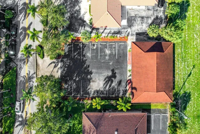 an aerial view of a house with garden space and street view