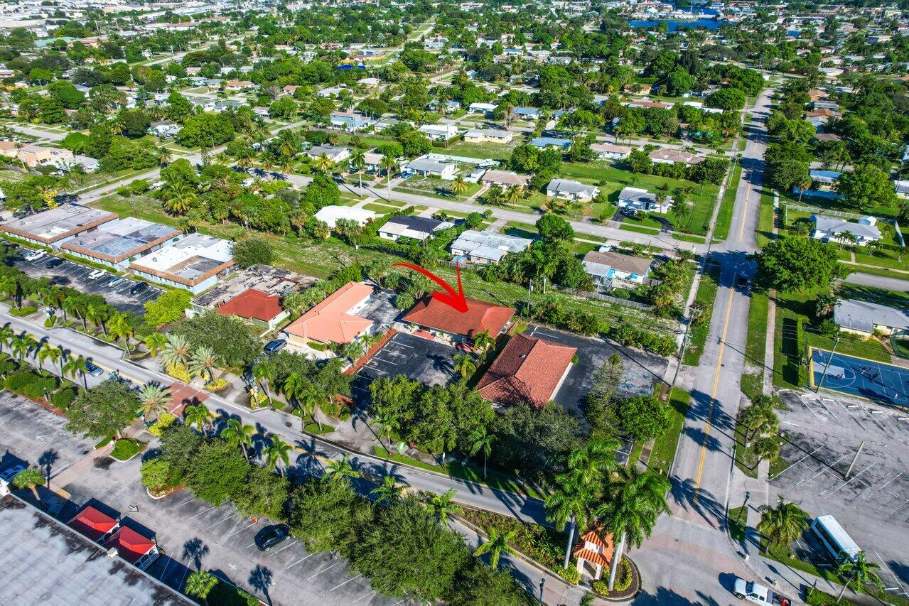 705 Park Avenue, Unit A Lake Park, FL 33403 - Photo 26 of 28 an aerial view of residential houses with outdoor space and trees all around