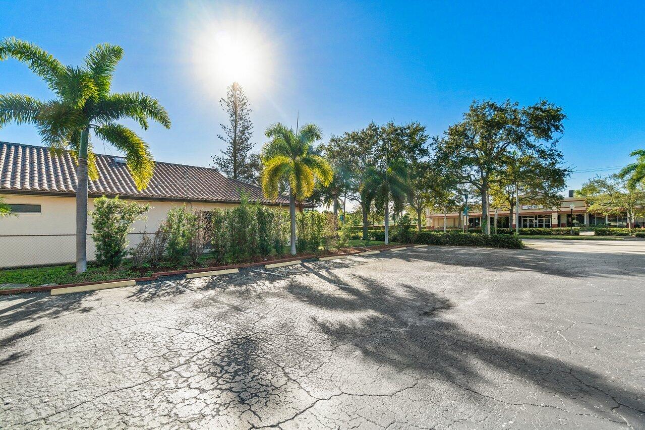 705 Park Avenue, Unit A Lake Park, FL 33403 - Photo 5 of 28 a view of a street with palm trees