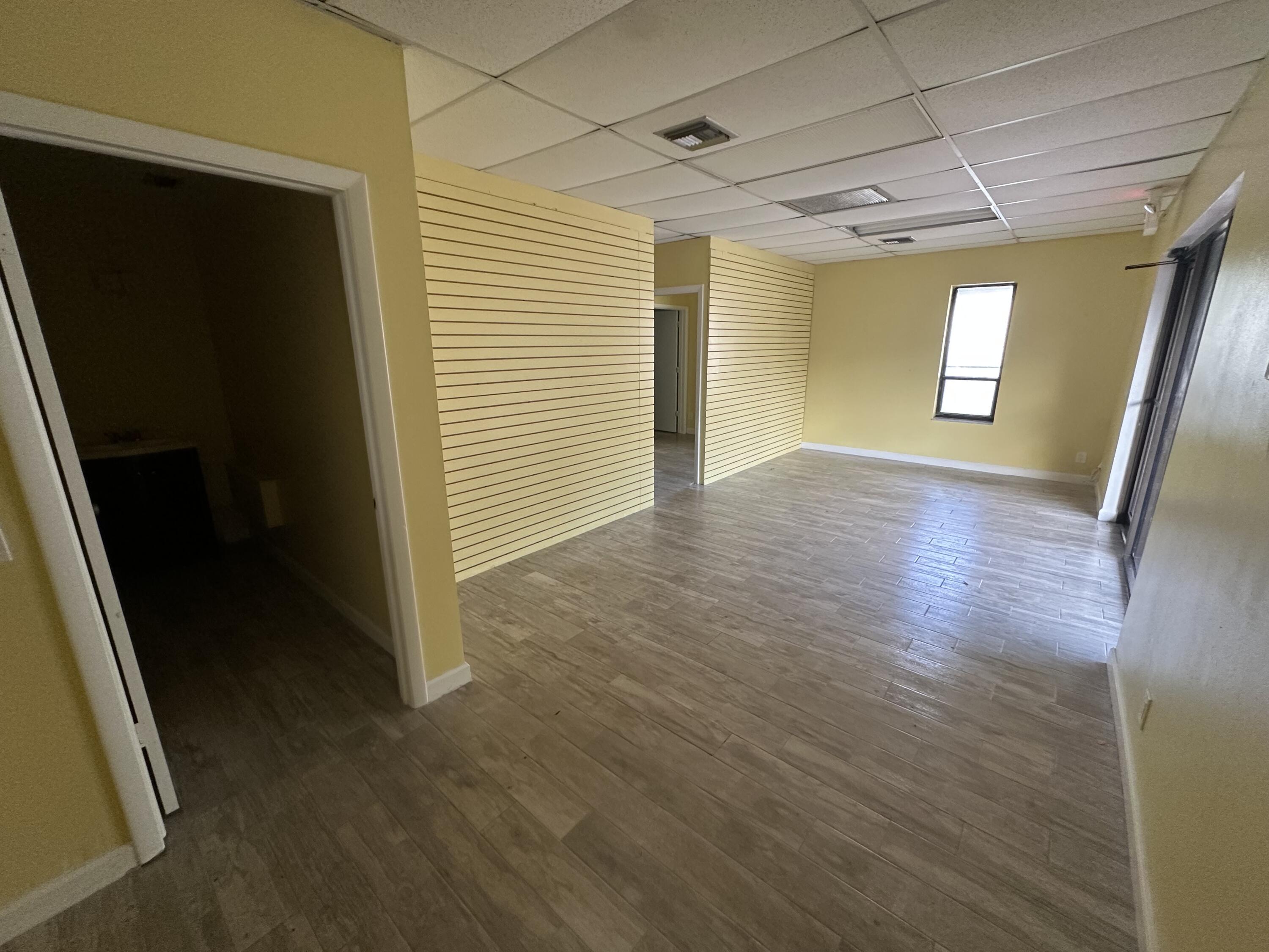 705 Park Avenue, Unit A Lake Park, FL 33403 - Photo 8 of 28 wooden floor in an empty room