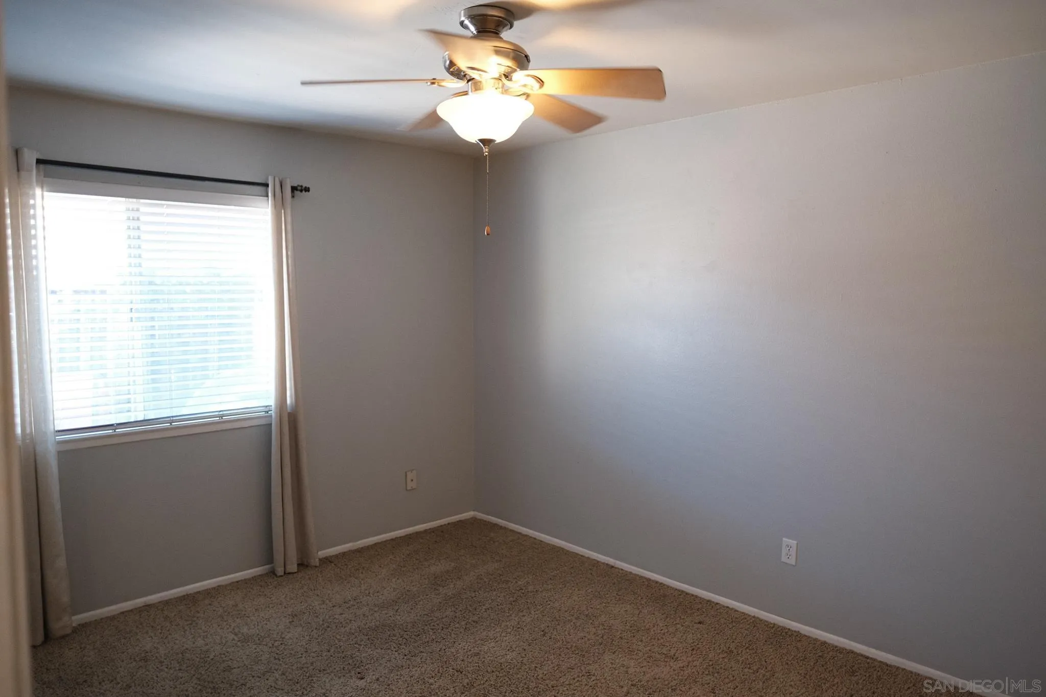 2142 Ridgeview Place Escondido, CA 92026 - Photo 14 of 29 an empty room with windows and fan