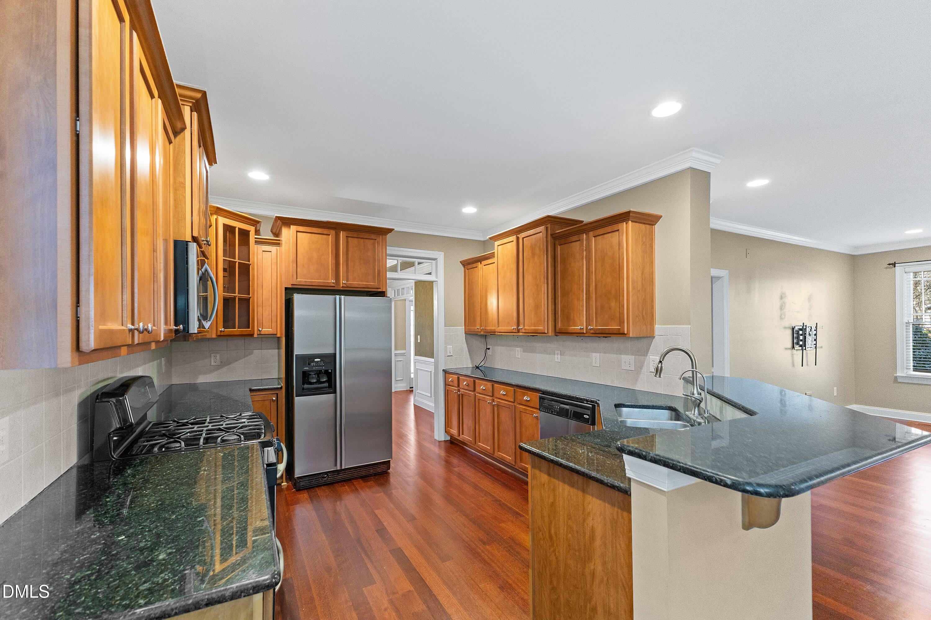 2124 Karns Place Raleigh, NC 27614 - Photo 18 of 74 a kitchen with stainless steel appliances granite countertop a sink a stove and a refrigerator