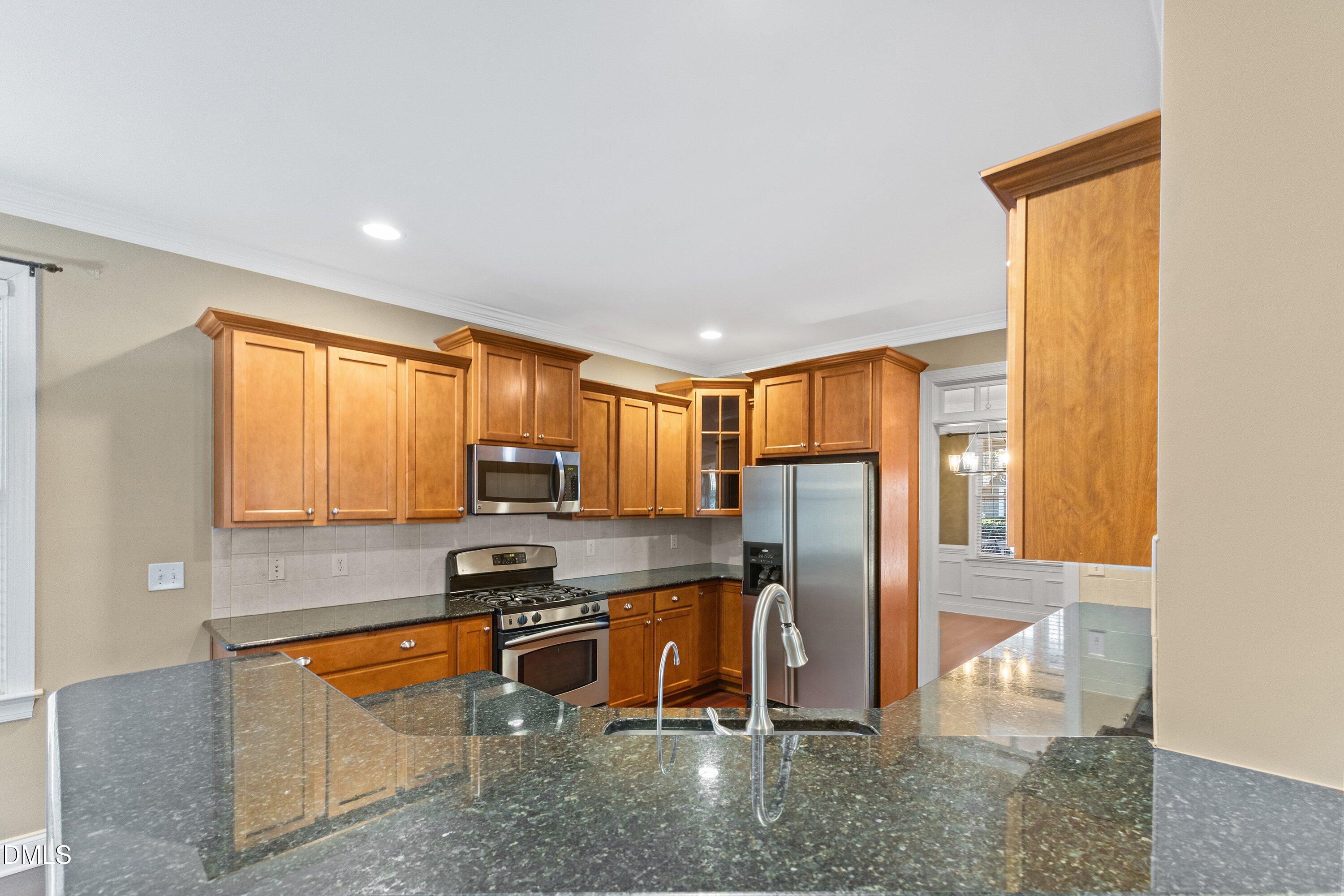 2124 Karns Place Raleigh, NC 27614 - Photo 19 of 74 a kitchen with stainless steel appliances granite countertop a refrigerator stove and sink