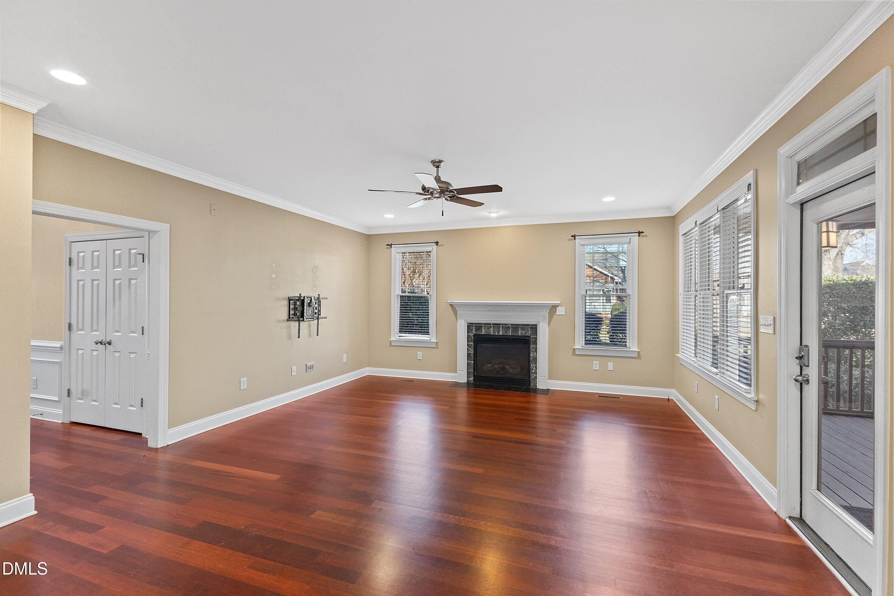 2124 Karns Place Raleigh, NC 27614 - Photo 25 of 74 an empty room with wooden floor fireplace and windows