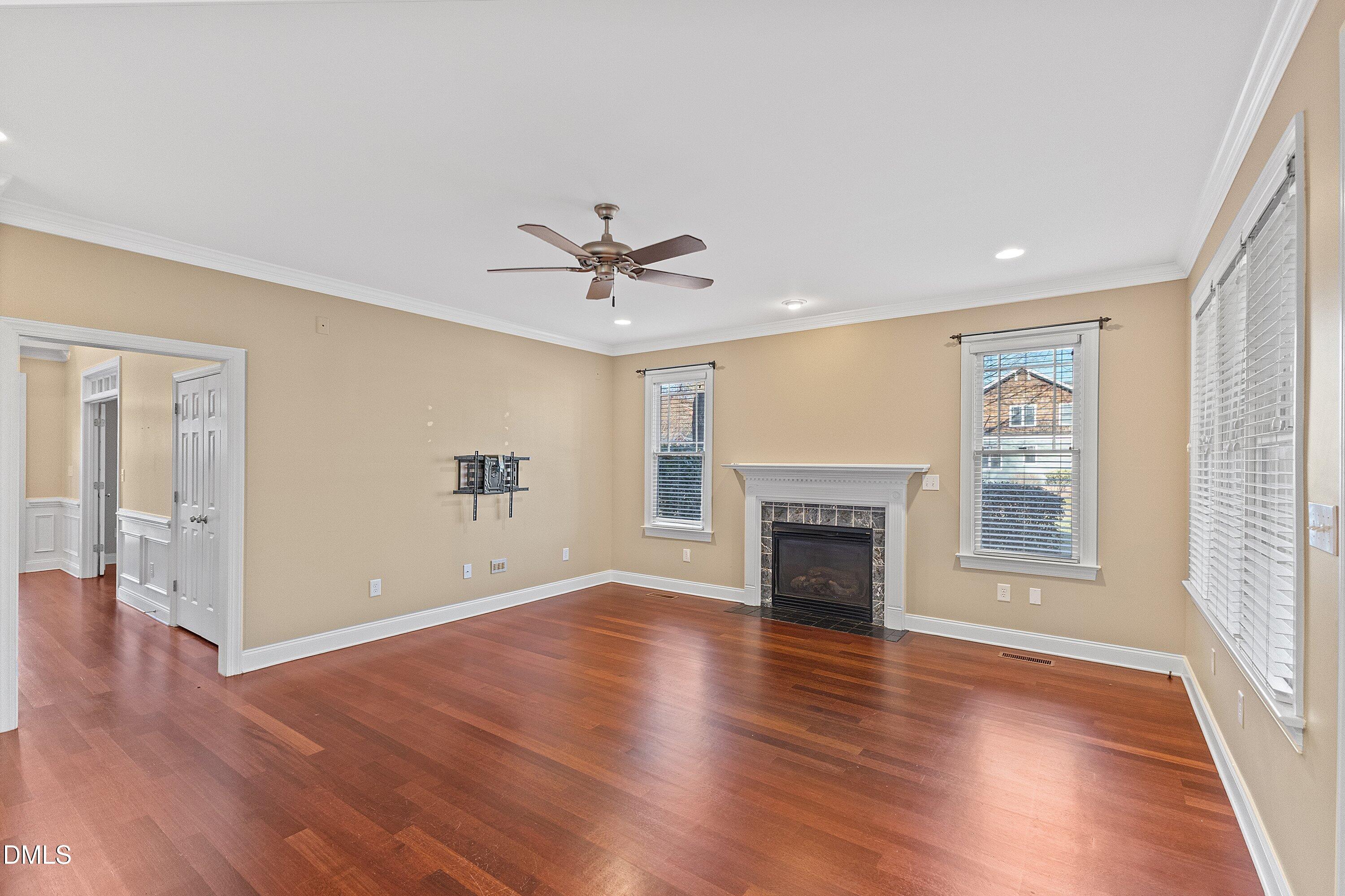 2124 Karns Place Raleigh, NC 27614 - Photo 29 of 74 a view of an empty room with a fireplace and wooden floor