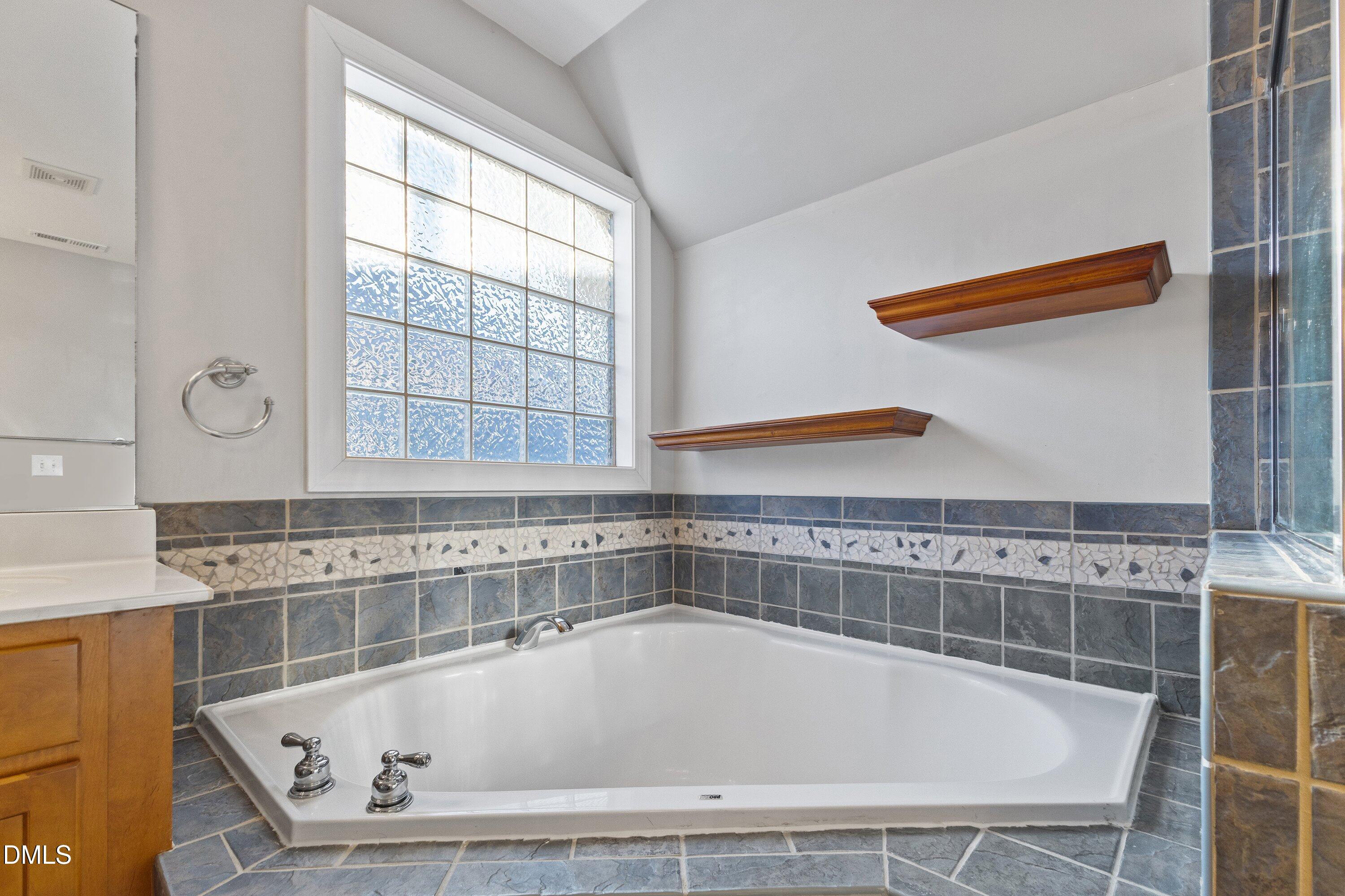 2124 Karns Place Raleigh, NC 27614 - Photo 39 of 74 a bathroom with a bathtub and next to a window