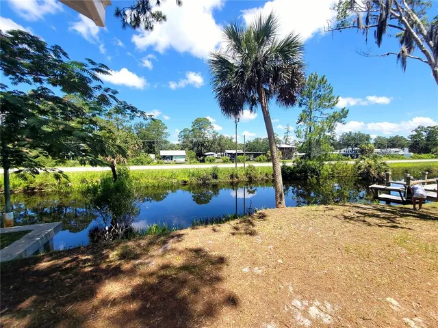 a view of a backyard with lawn chairs and a fire pit