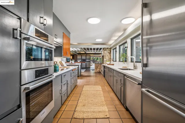 a bathroom with a double vanity sink mirror and shower